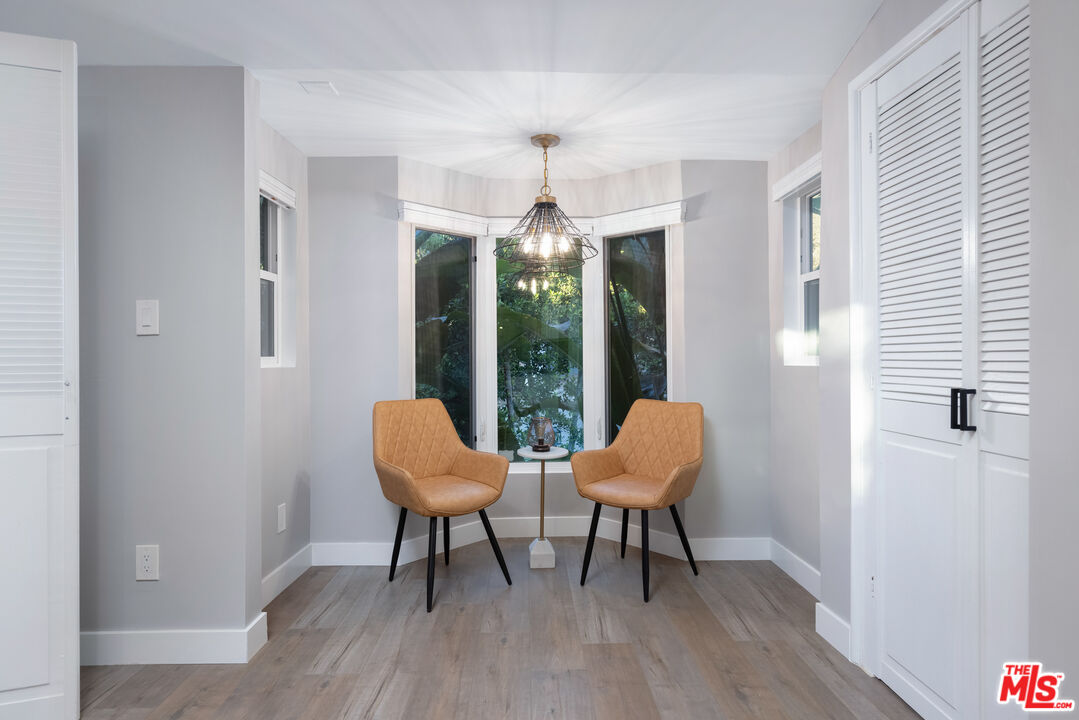 9476 Hidden Valley Place Beverly Hills, CA 90210 - Photo 42 of 43 a dining room with furniture window and wooden floor