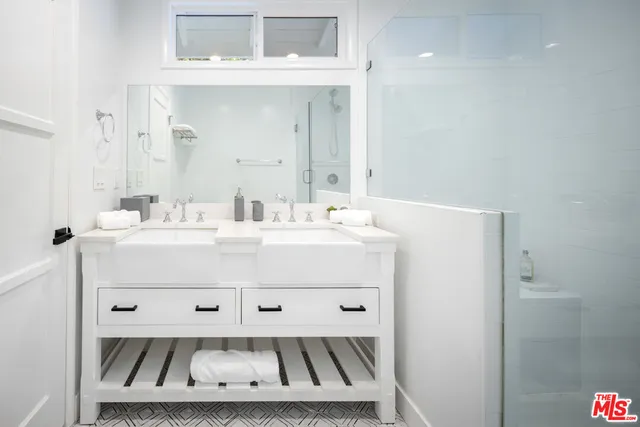 a bathroom with a sink mirror and vanity