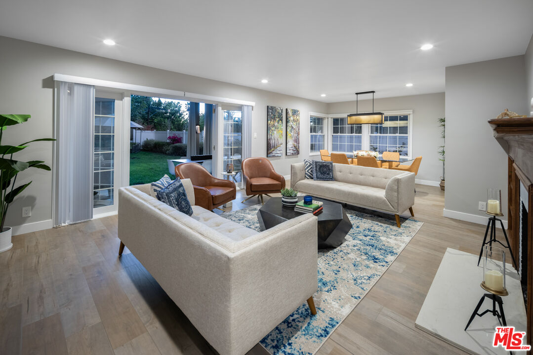 9476 Hidden Valley Place Beverly Hills, CA 90210 - Photo 9 of 43 a living room with furniture and a large window