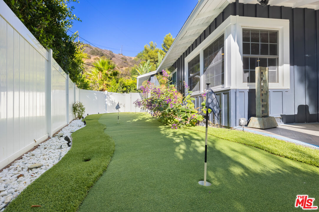 9476 Hidden Valley Place Beverly Hills, CA 90210 - Photo 10 of 43 a view of a garden with a fountain