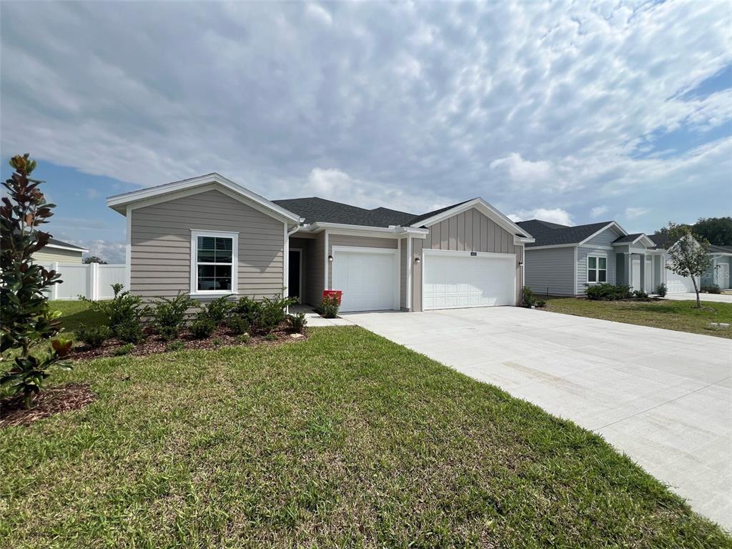 4605 Southwest 83rd Loop Ocala, FL 34476 - Photo 1 of 1 a front view of a house with a yard and garage