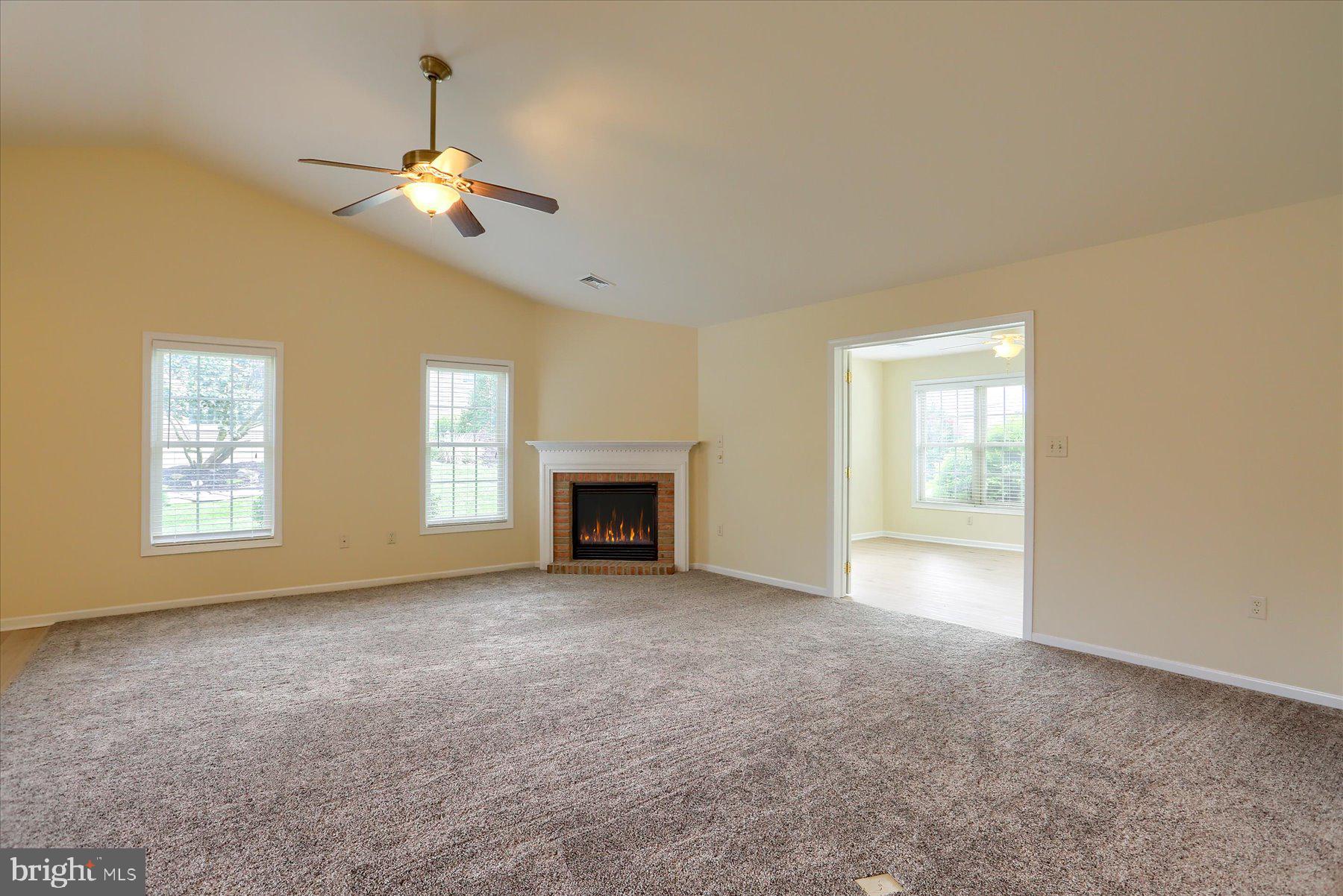 802 Heather Ridge Manheim, PA 17545 - Photo 11 of 41 an empty room with windows fireplace and cabinet