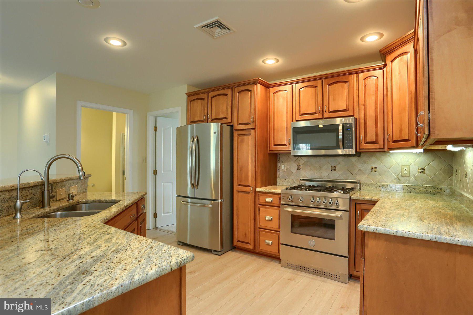 802 Heather Ridge Manheim, PA 17545 - Photo 6 of 41 a kitchen with stainless steel appliances granite countertop a refrigerator a stove top oven a sink and dishwasher