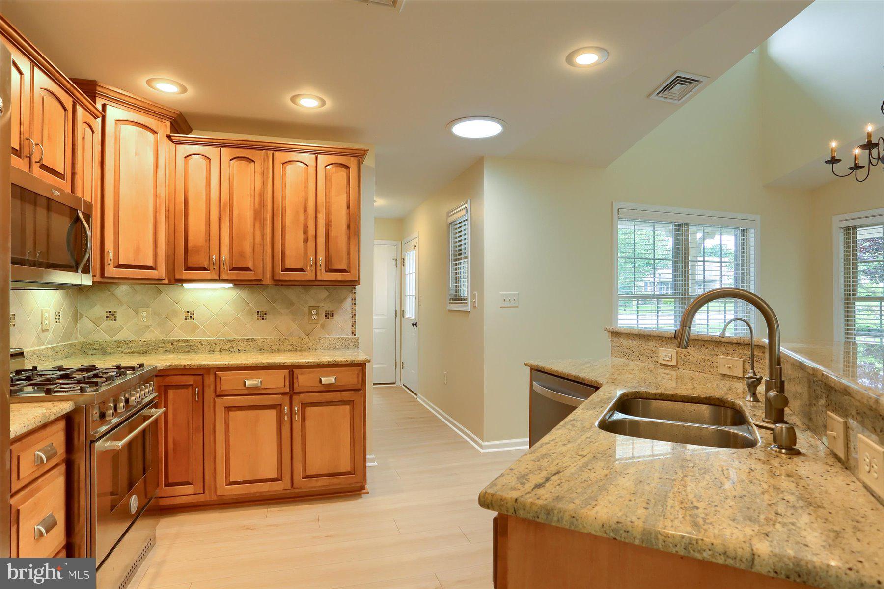 802 Heather Ridge Manheim, PA 17545 - Photo 8 of 41 a kitchen with stainless steel appliances granite countertop a stove a sink and a microwave