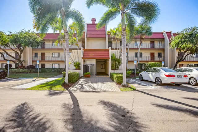 a view of multiple houses with palm trees