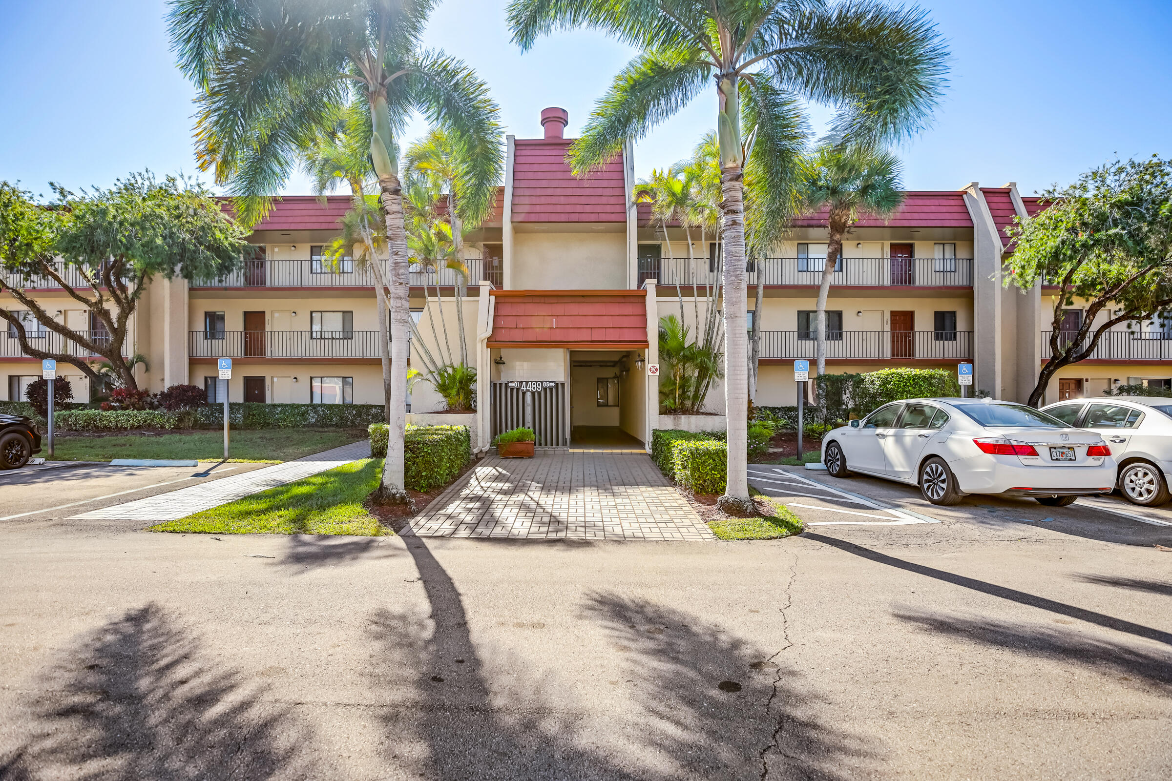 a view of multiple houses with palm trees