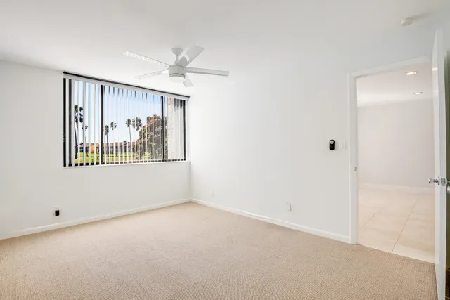 a view of an empty room with a painting on the wall