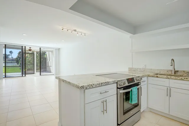 a view of a kitchen with a sink cabinets and wooden floor