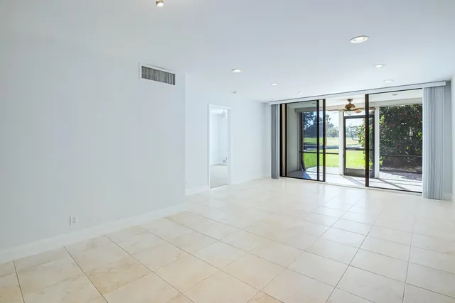 a view of an empty room with glass door