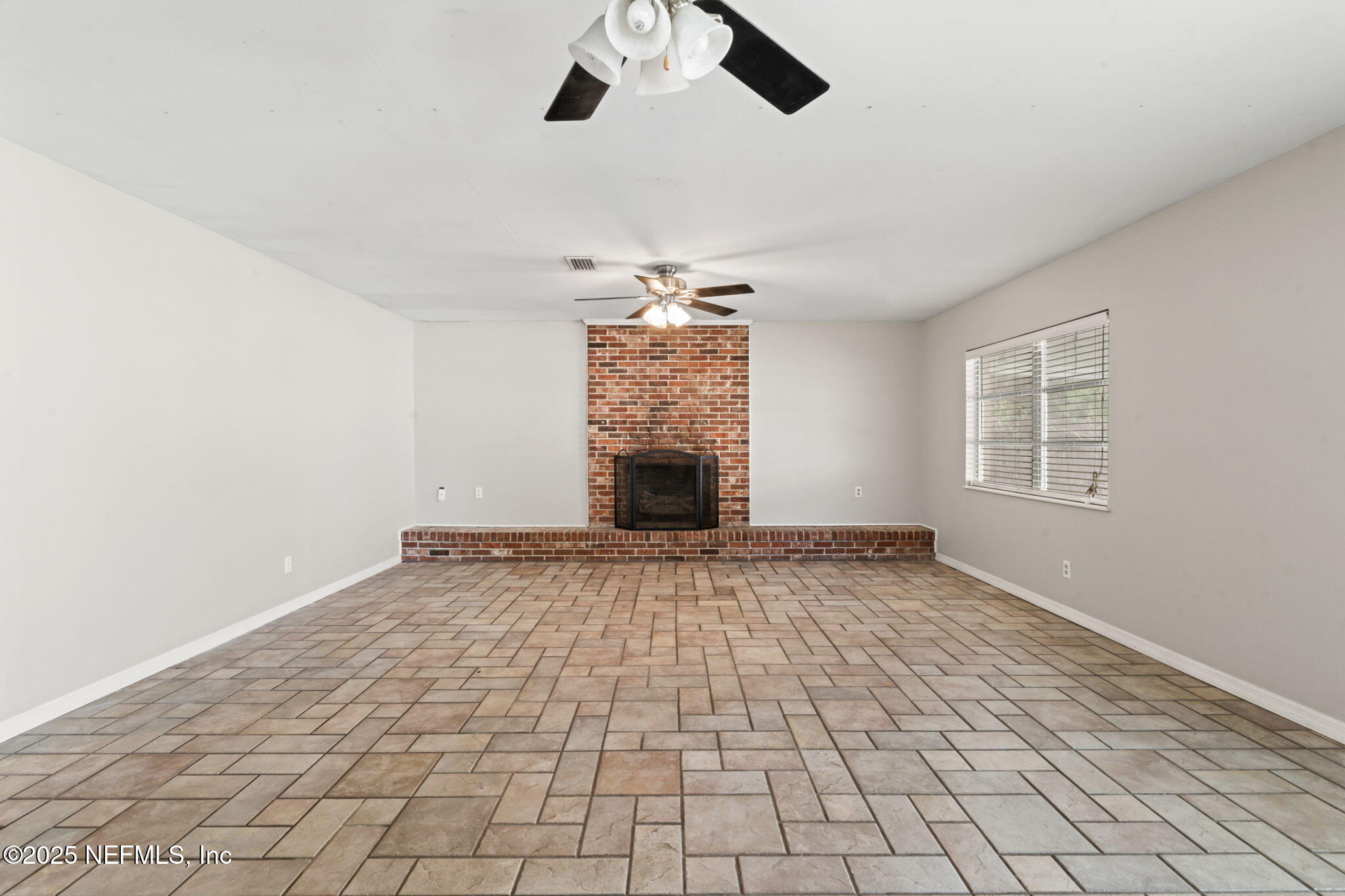 17896 Highway 16 Starke, FL 32091 - Photo 21 of 57 a view of an empty room with window and chandelier fan
