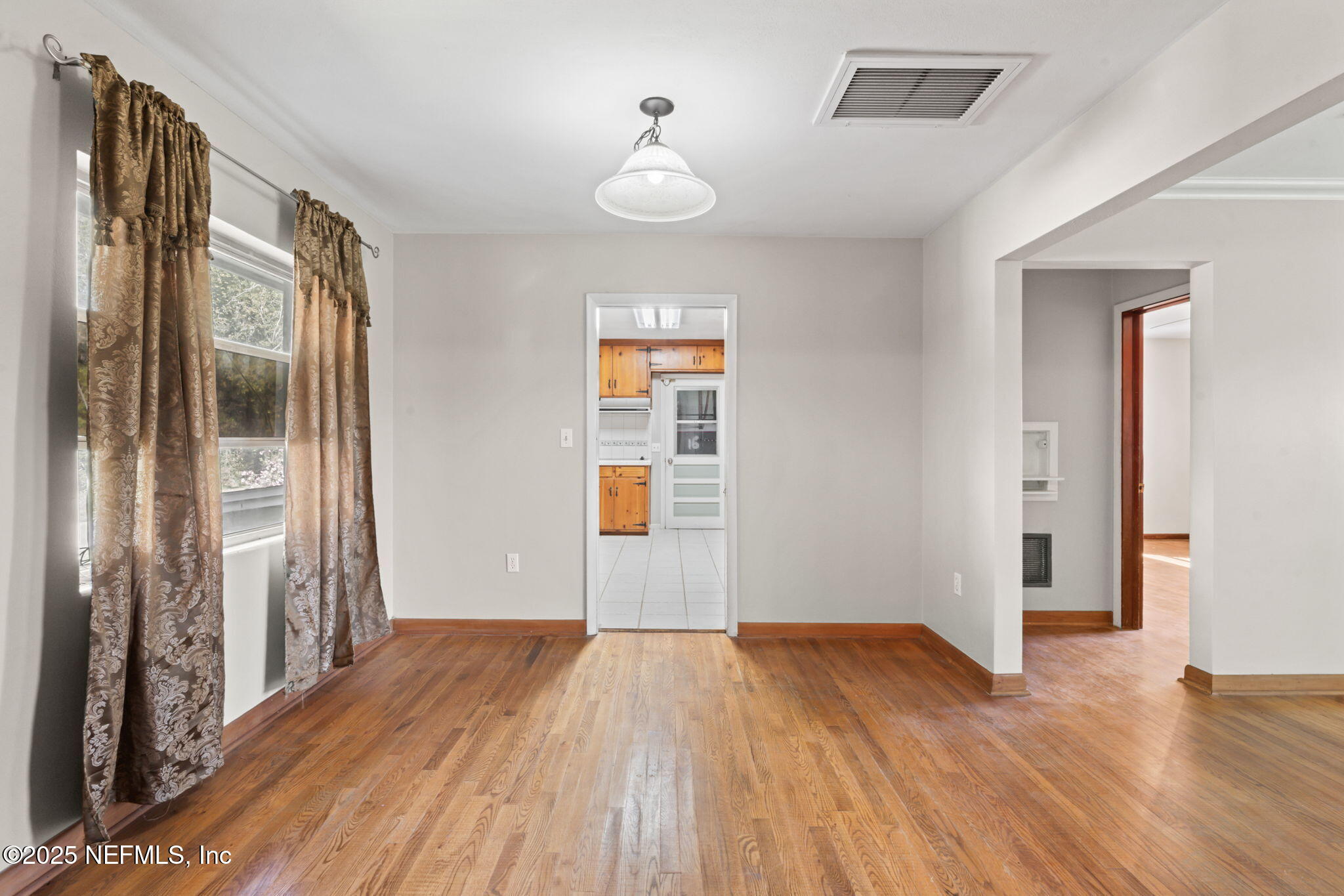17896 Highway 16 Starke, FL 32091 - Photo 24 of 57 an empty room with wooden floor and windows