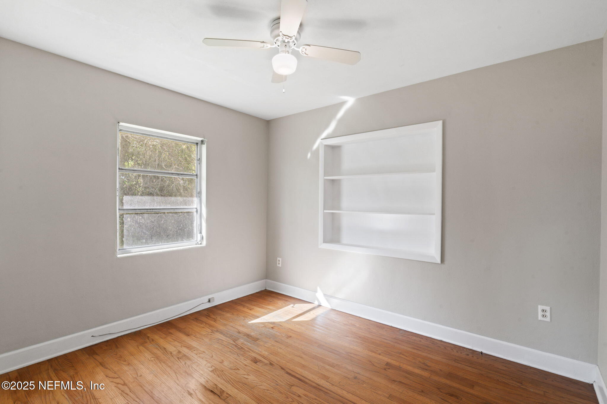 17896 Highway 16 Starke, FL 32091 - Photo 33 of 57 a view of an empty room with wooden floor and a window