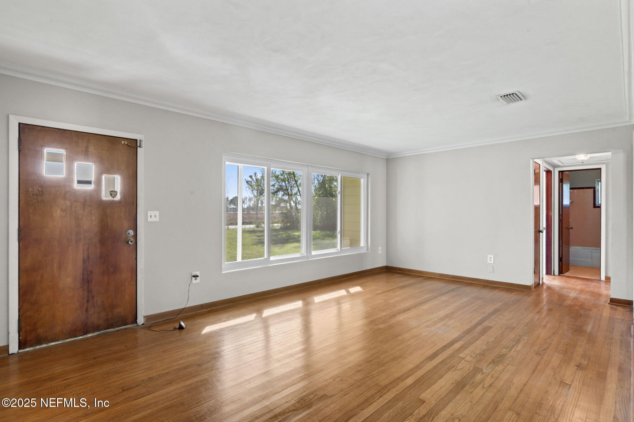 17896 Highway 16 Starke, FL 32091 - Photo 8 of 57 a view of an empty room with wooden floor and a window