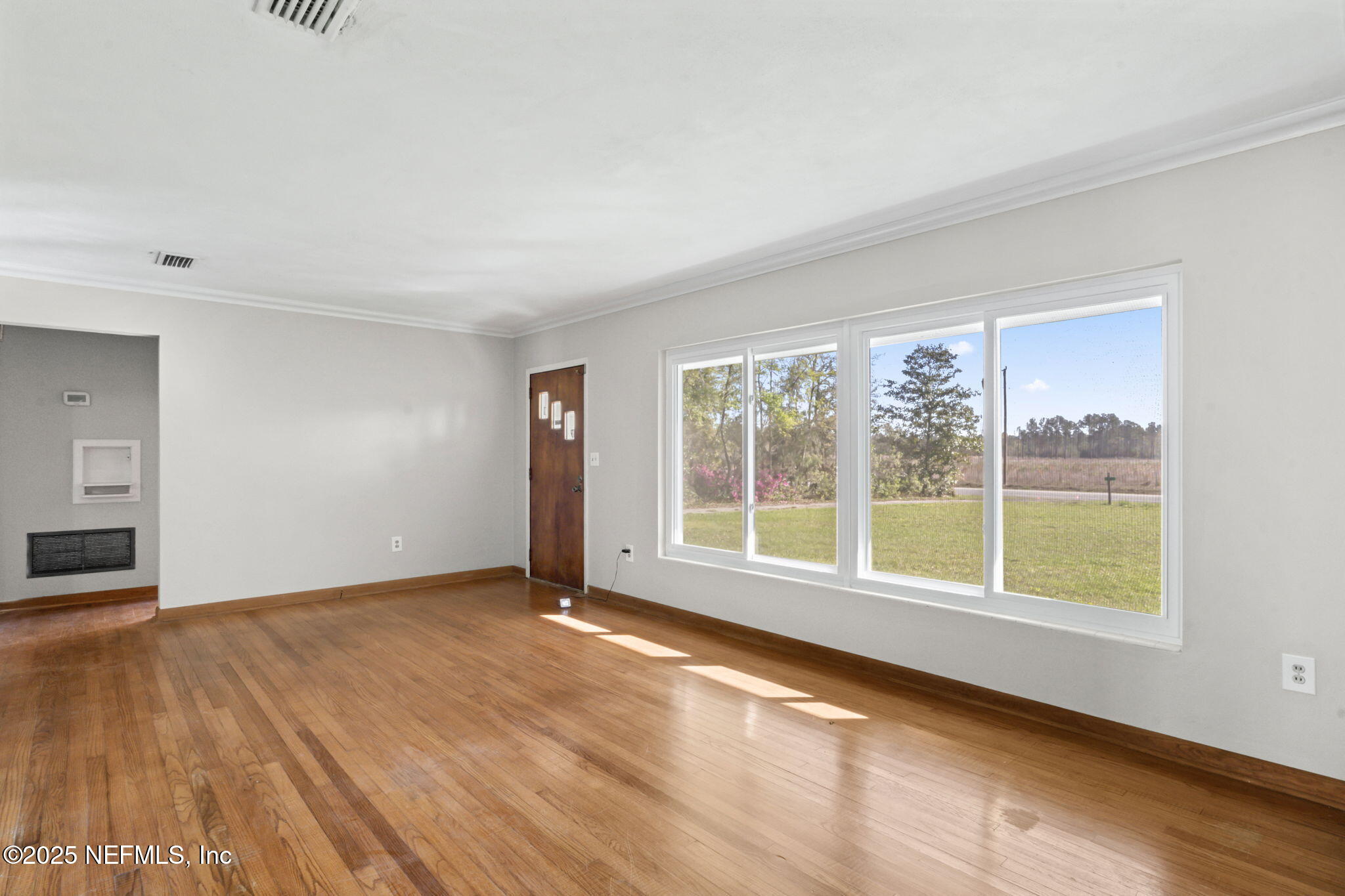 17896 Highway 16 Starke, FL 32091 - Photo 9 of 57 a view of an empty room with a window and wooden floor