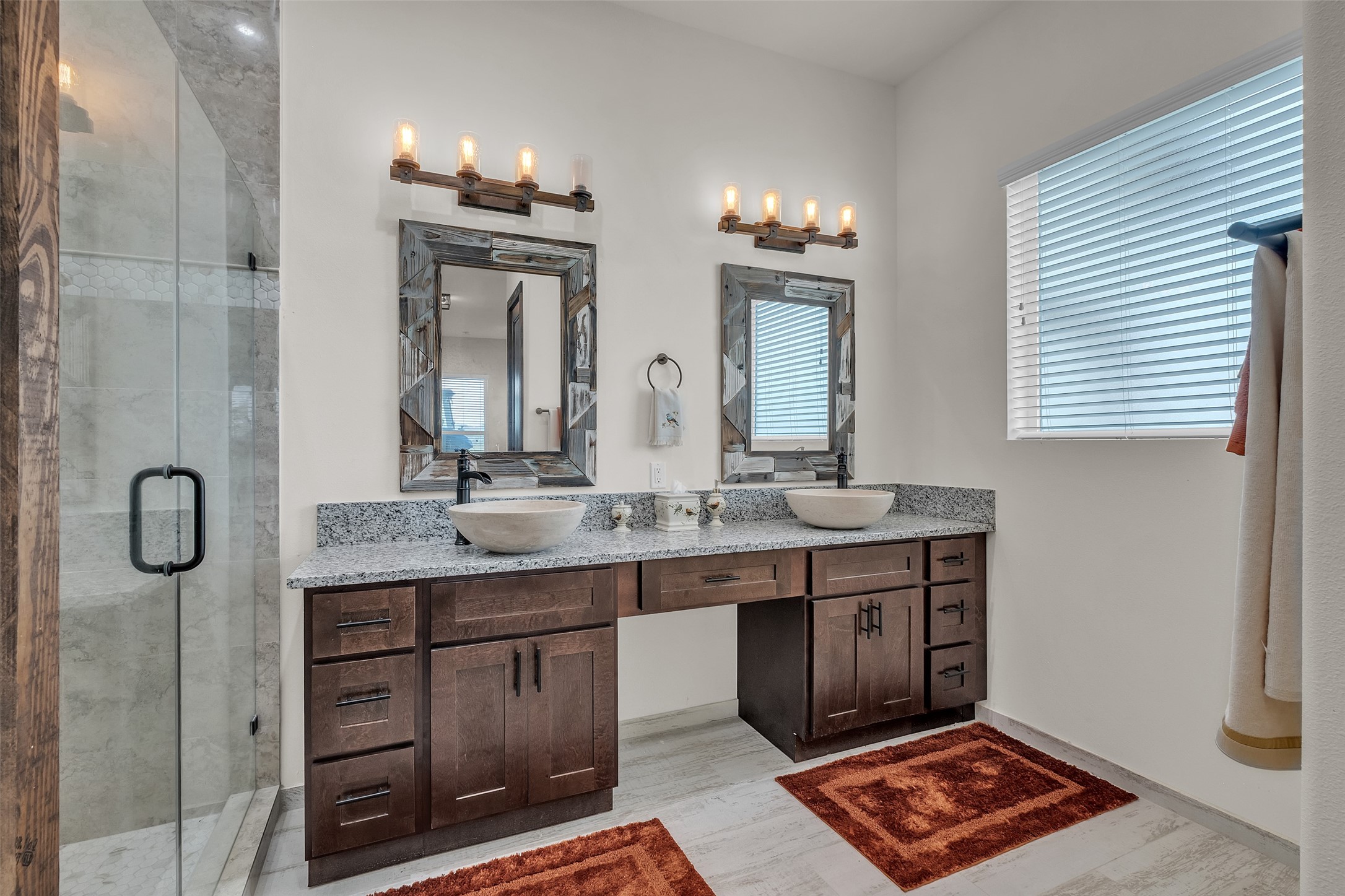 1048 11th Street Columbus, TX 78934 - Photo 22 of 48 a bathroom with double vanity and a mirror