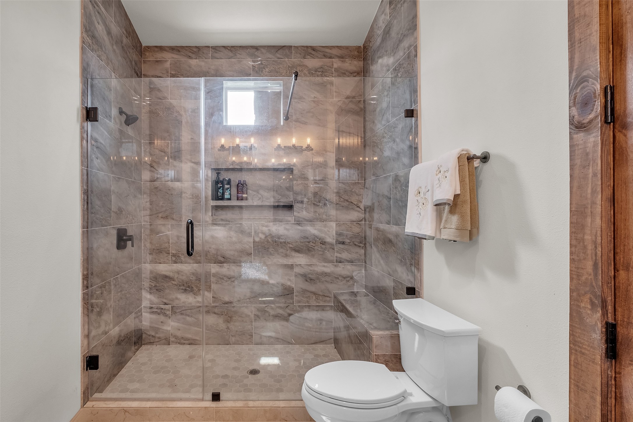 1048 11th Street Columbus, TX 78934 - Photo 23 of 48 a bathroom with a shower a toilet and a shower