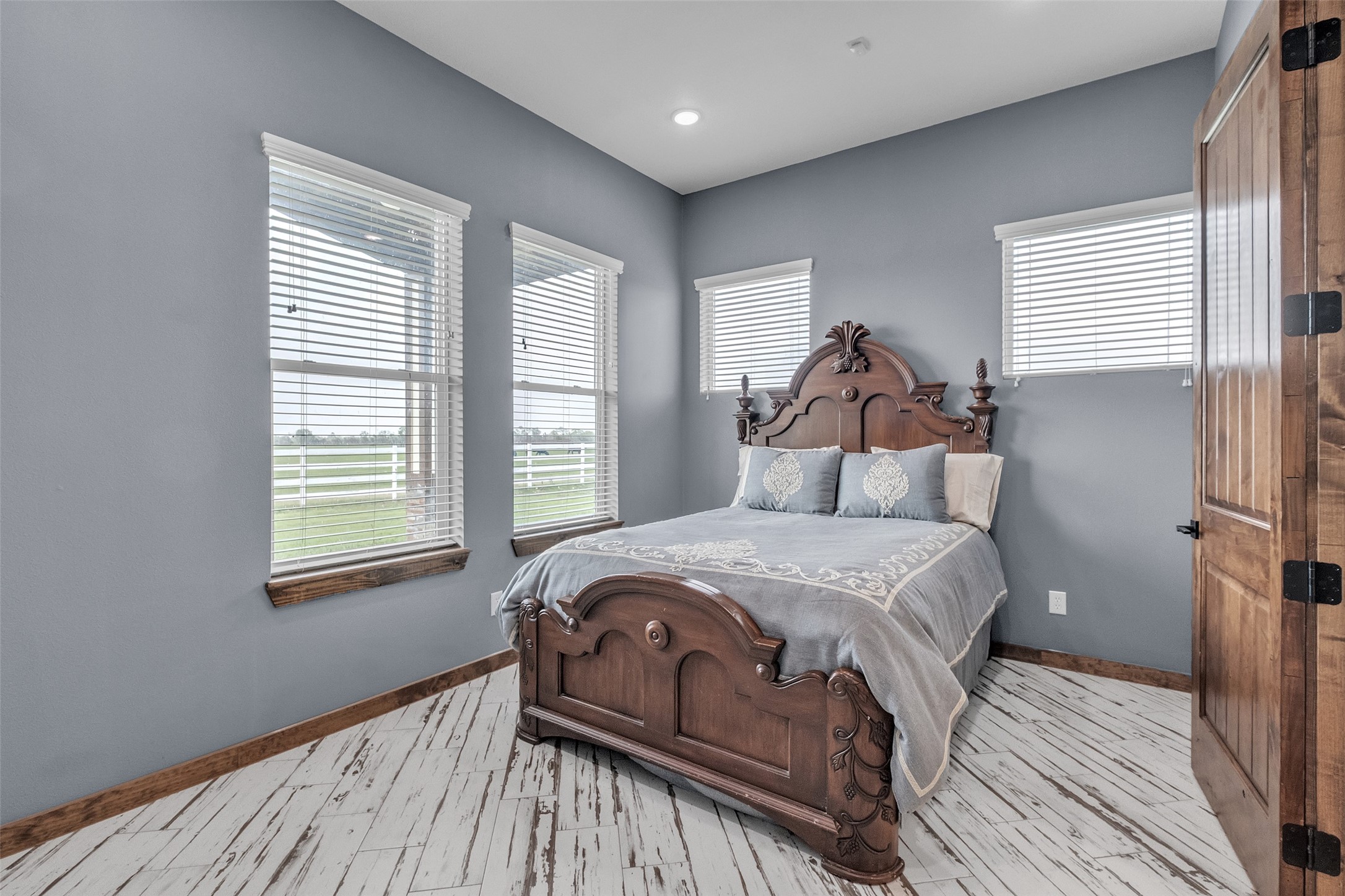 1048 11th Street Columbus, TX 78934 - Photo 28 of 48 a bedroom with a bed and wooden floor