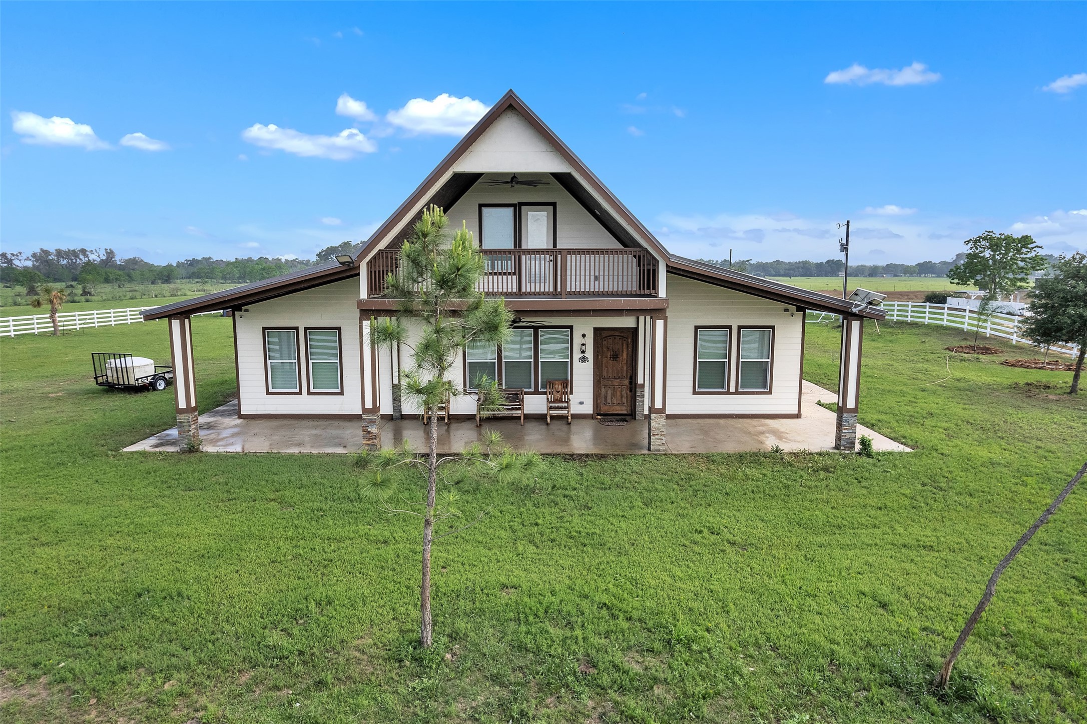 1048 11th Street Columbus, TX 78934 - Photo 3 of 48 a front view of a house with a garden and yard