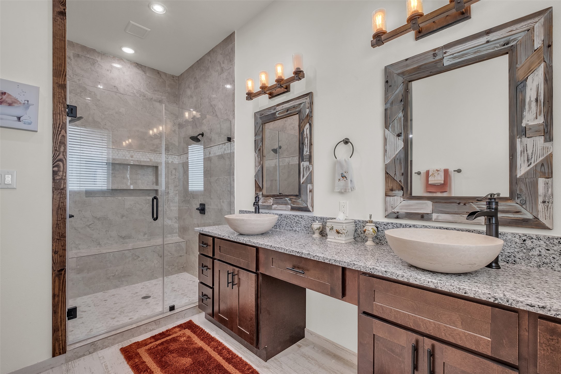 1048 11th Street Columbus, TX 78934 - Photo 35 of 48 a bathroom with a granite countertop double vanity sink mirror and shower