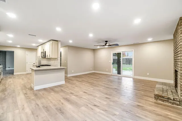 a view of large kitchen with a sink and a large window