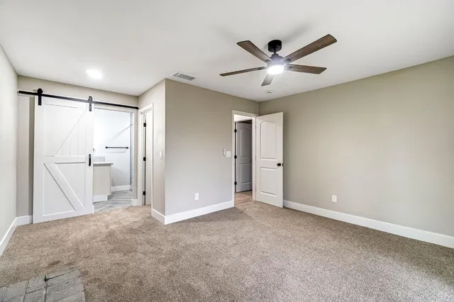 a view of empty room with ceiling fan