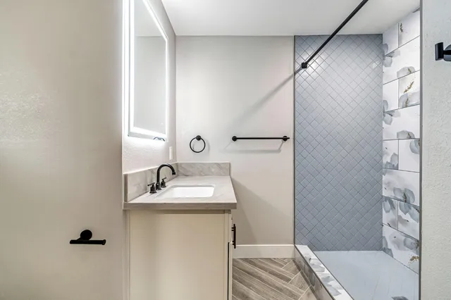 a bathroom with a sink and mirror