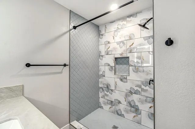 a bathroom with a shower and a sink