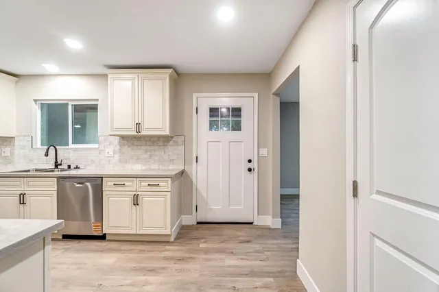 a kitchen with stainless steel appliances granite countertop a stove and a sink