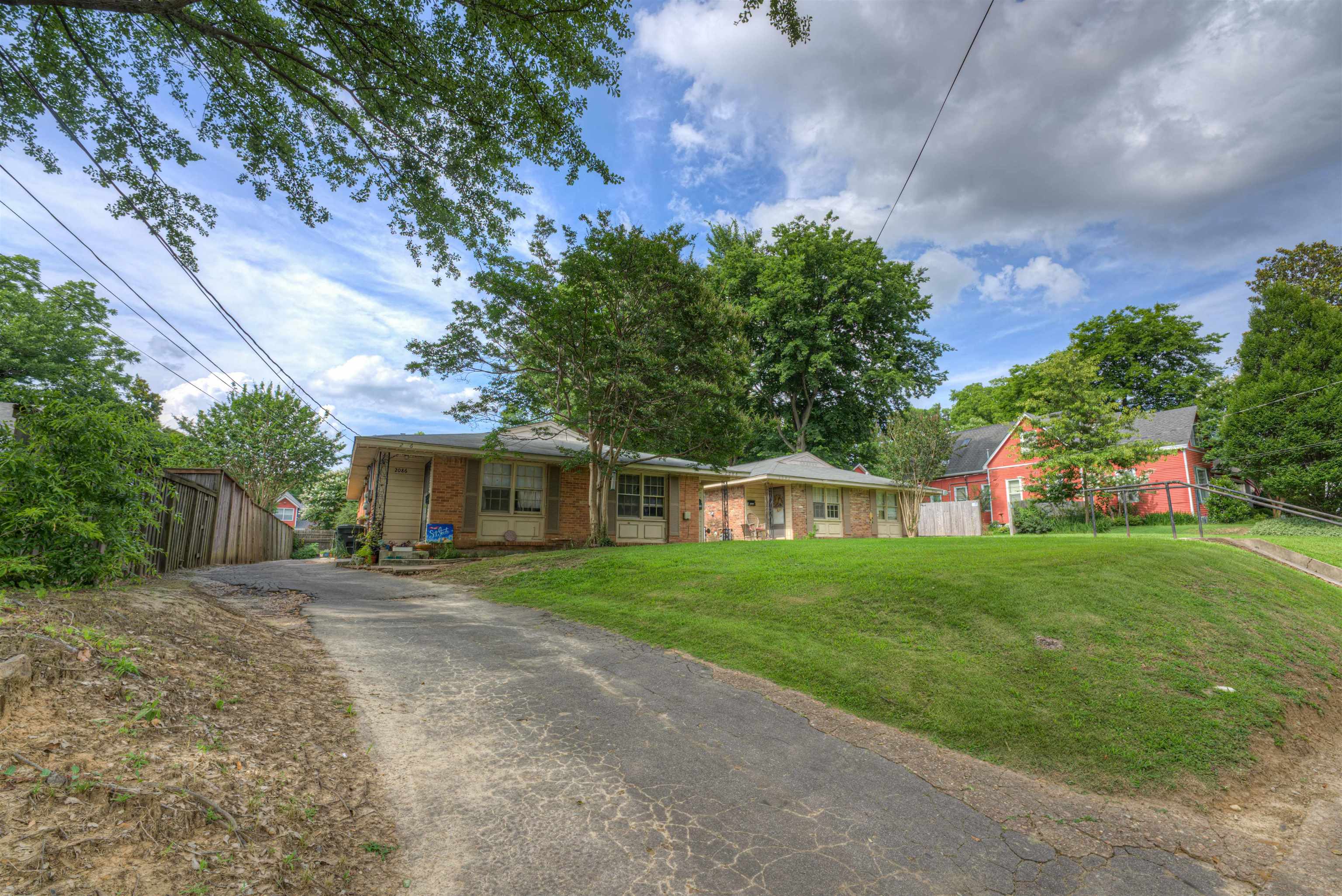 2086 Harbert Avenue Memphis, TN 38104 - Photo 5 of 16 a front view of a house with a yard and trees