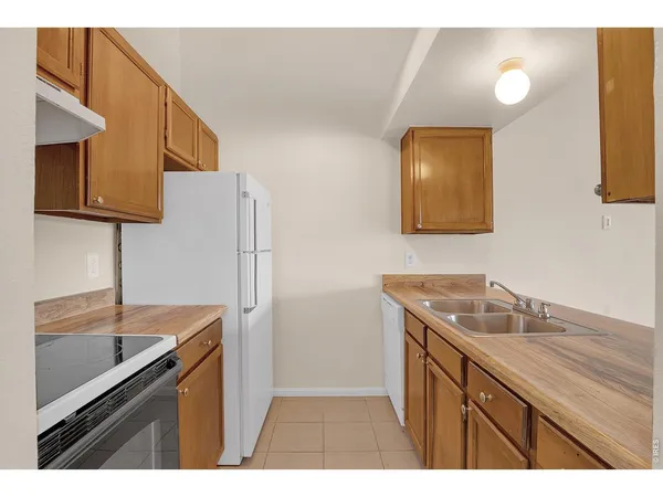 a kitchen with a sink and a refrigerator