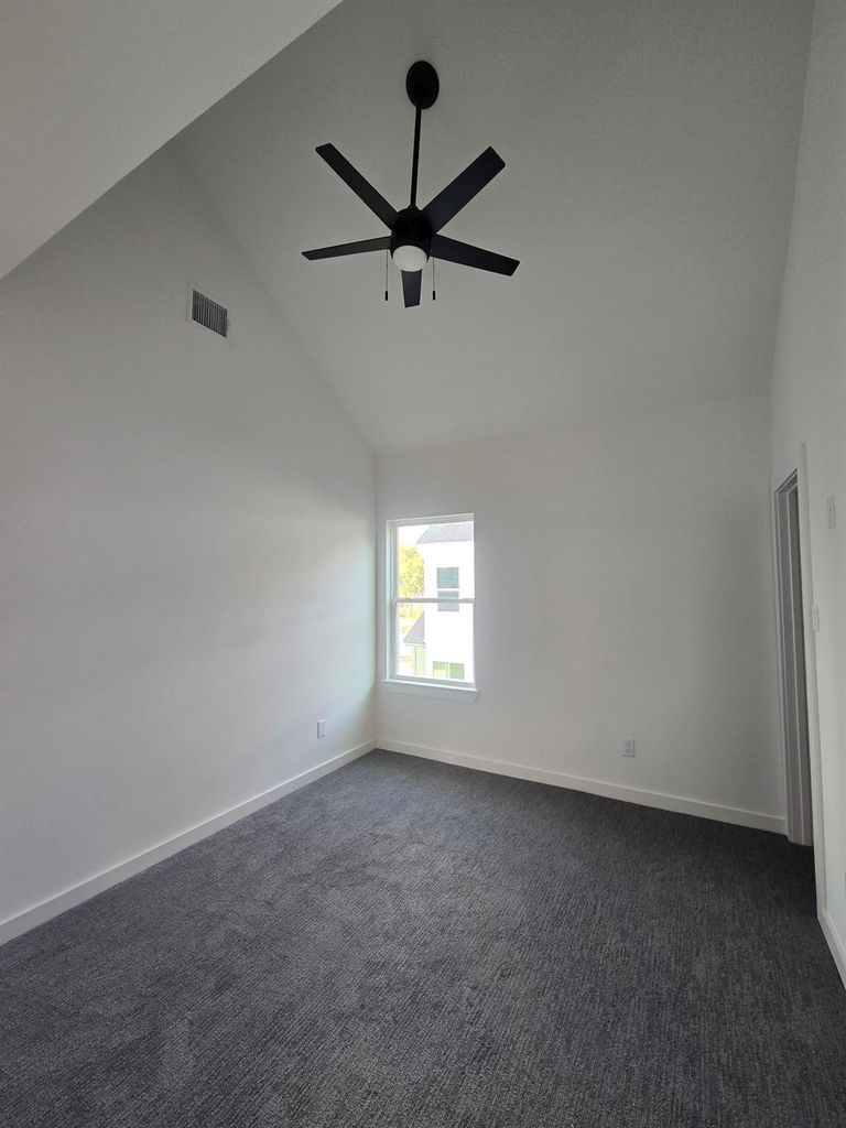 9630 Burden Street Houston, TX 77093 - Photo 11 of 15 an empty room with ceiling fan and window
