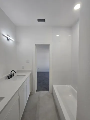 a bathroom with a sink a shower and bathtub