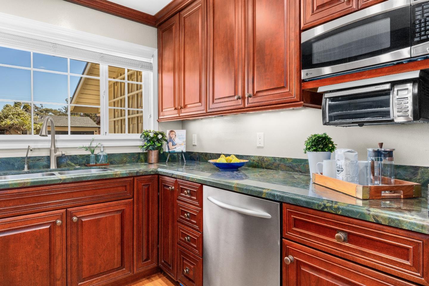 105 Wesley Street Capitola, CA 95010 - Photo 21 of 55 a kitchen with stainless steel appliances granite countertop a sink a microwave and cabinets