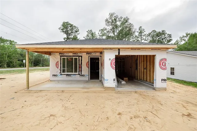 a view of a house with a snow in the yard