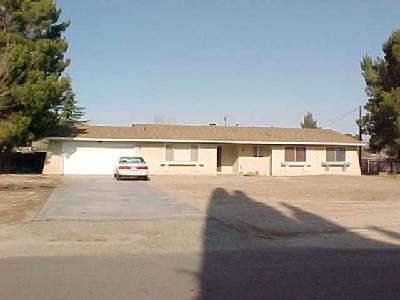 19666 Symeron Road Apple Valley, CA 92307 - Photo 1 of 1 a front view of a house with a yard and balcony