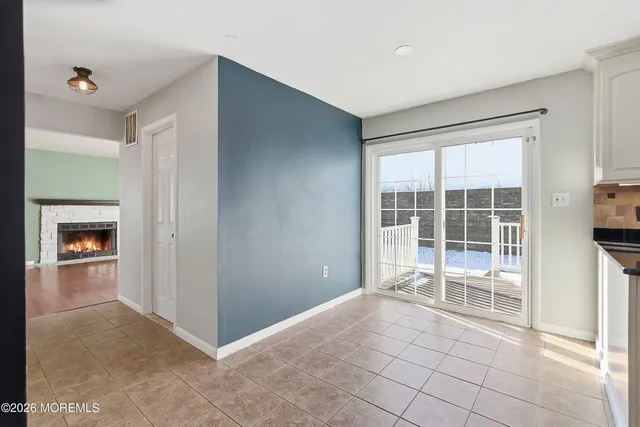 a view of a room with a large window and an empty room