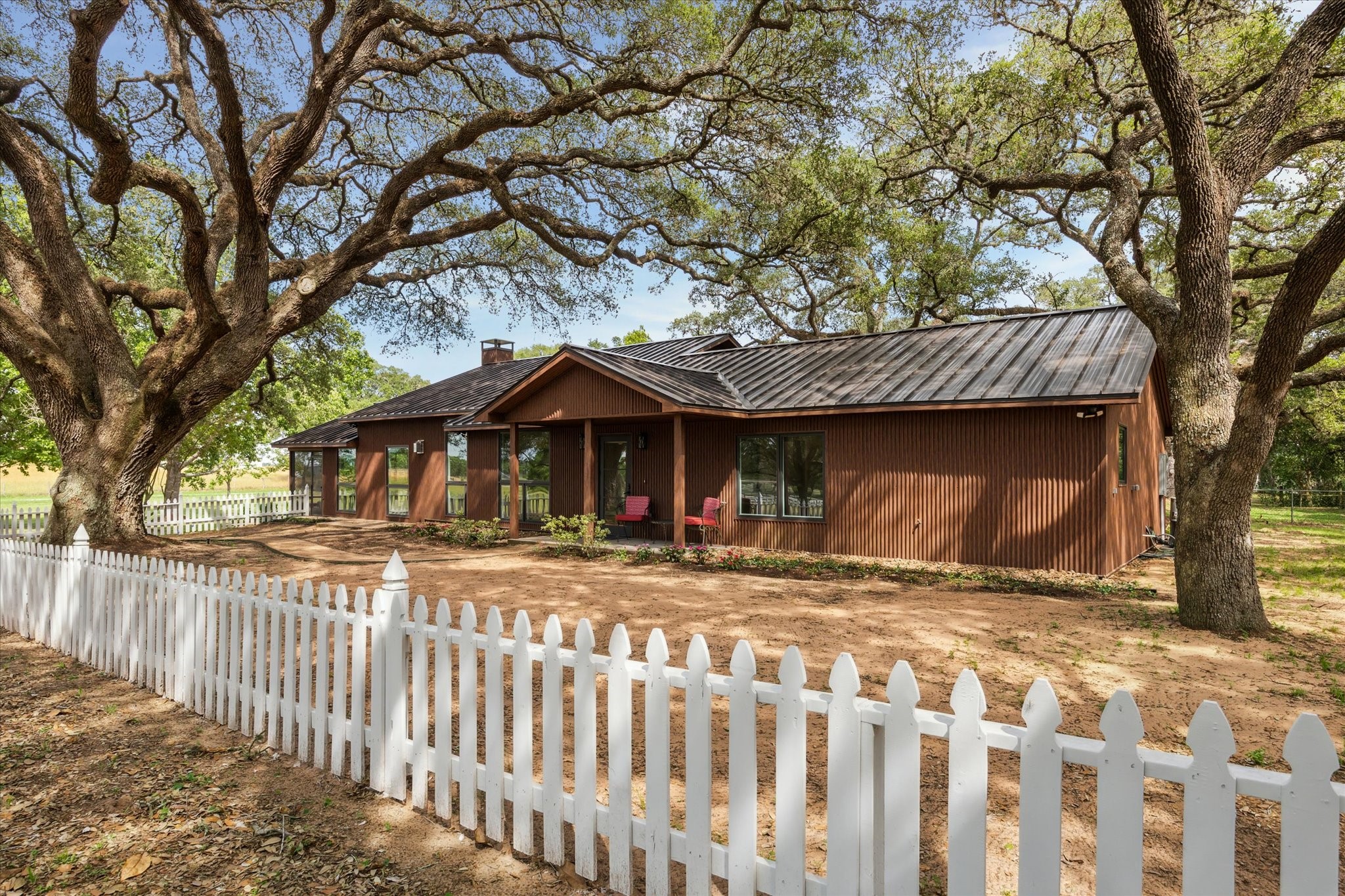 3834 Farm To Market Road 949 Cat Spring, TX 78933 - Photo 11 of 50 a view of a yard with wooden fence and a large tree