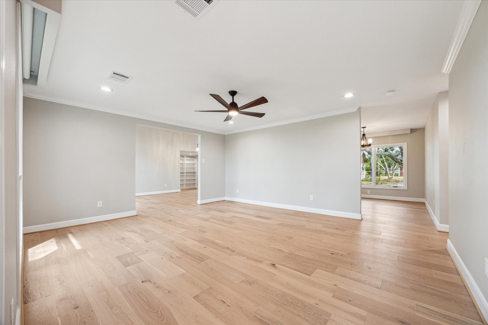 3834 Farm To Market Road 949 Cat Spring, TX 78933 - Photo 13 of 50 a view of an empty room with wooden floor and a window