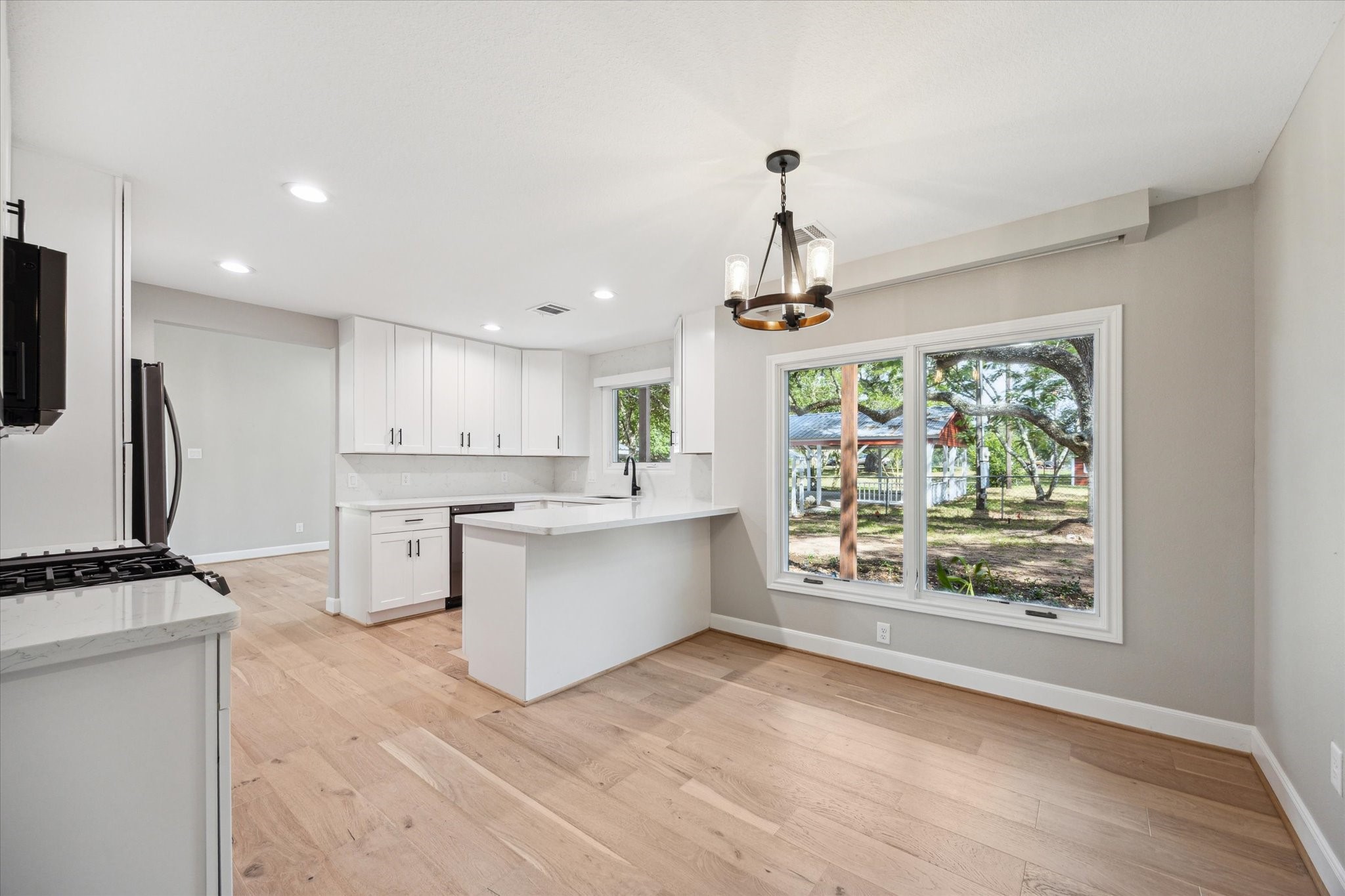 3834 Farm To Market Road 949 Cat Spring, TX 78933 - Photo 21 of 50 a kitchen with stainless steel appliances a stove top oven and a refrigerator