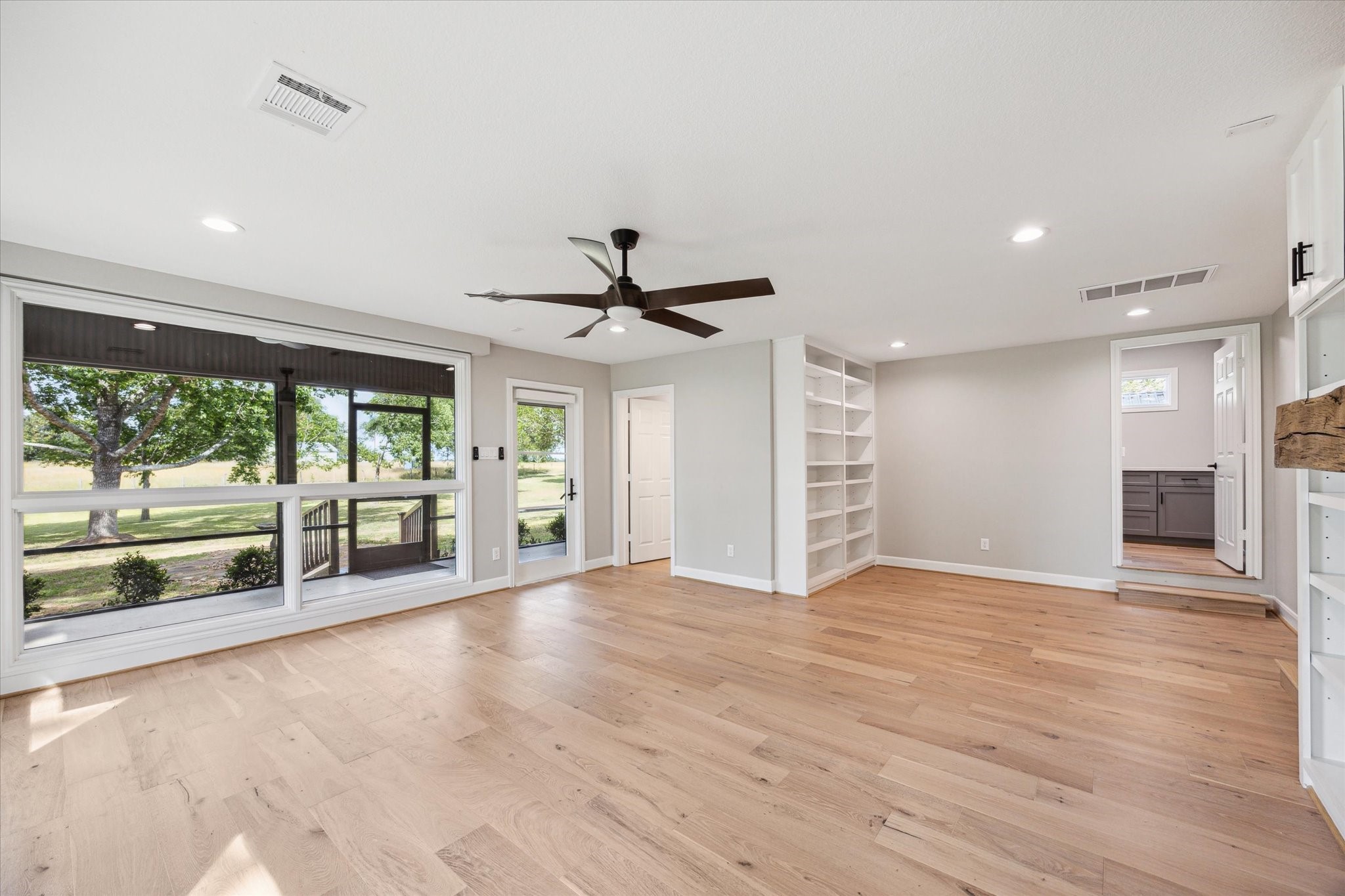3834 Farm To Market Road 949 Cat Spring, TX 78933 - Photo 23 of 50 a view of an empty room with a window and wooden floor