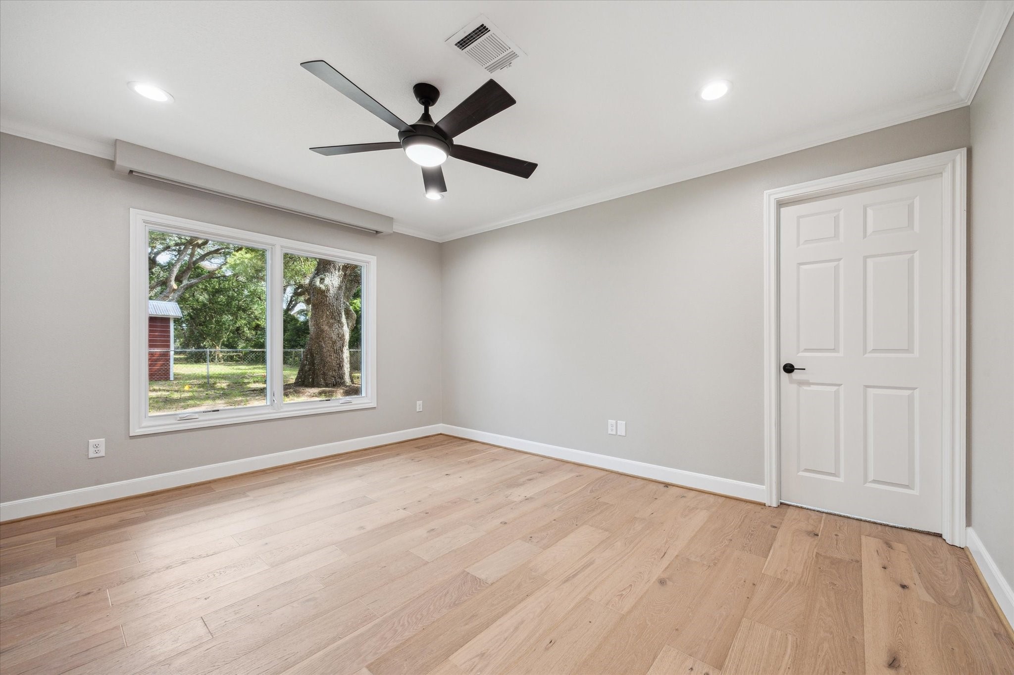3834 Farm To Market Road 949 Cat Spring, TX 78933 - Photo 36 of 50 an empty room with wooden floor fan and windows