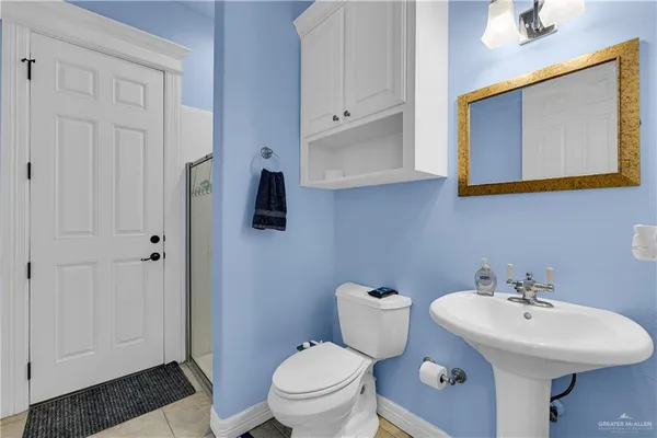 a bathroom with a sink toilet and mirror