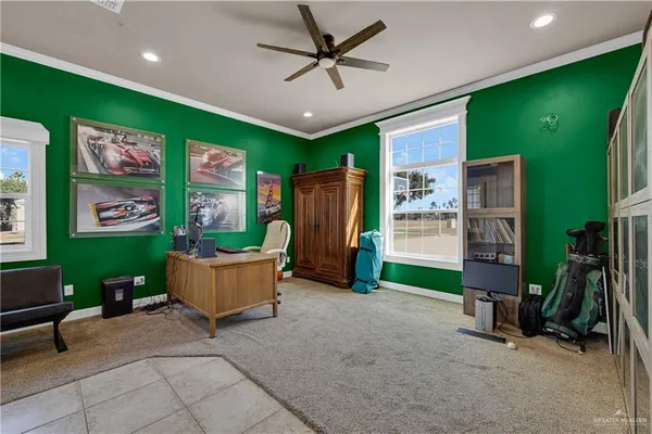 a spacious bedroom with a bed and a chandelier