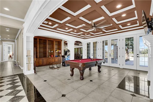 a room with pool table and glass windows