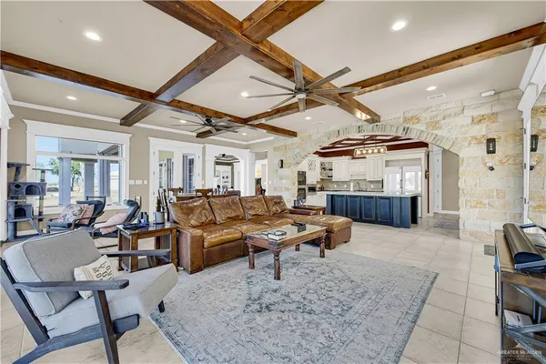 a living room with lots of furniture and kitchen view