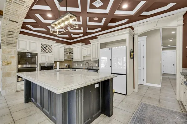 a large kitchen with a table and chairs