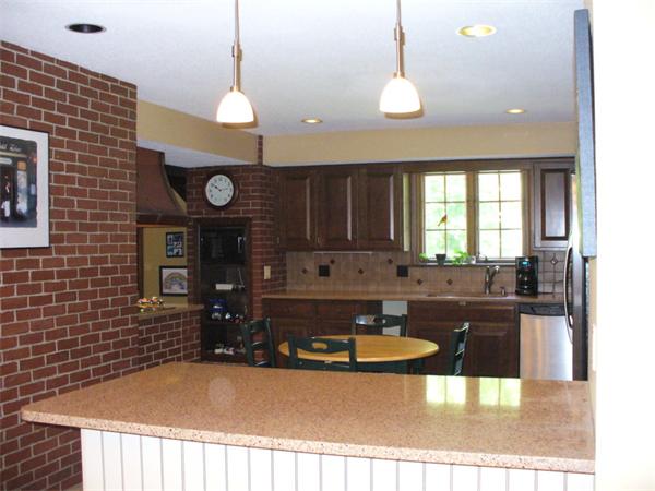 180 Reservoir Road Westhampton, MA 01027 - Photo 13 of 28 a kitchen with a table chairs and a fireplace