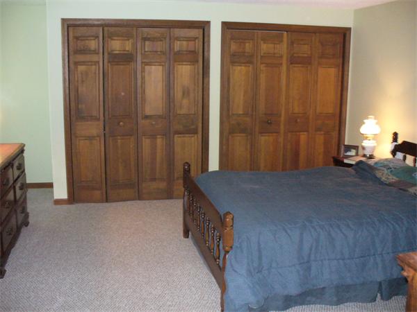 180 Reservoir Road Westhampton, MA 01027 - Photo 23 of 28 a bedroom with a bed and a chandelier