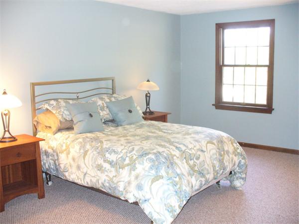 180 Reservoir Road Westhampton, MA 01027 - Photo 24 of 28 a large bed sitting in a bedroom next to a window