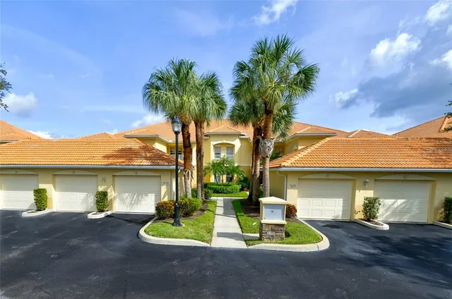 a front view of a house with a yard garage and outdoor seating
